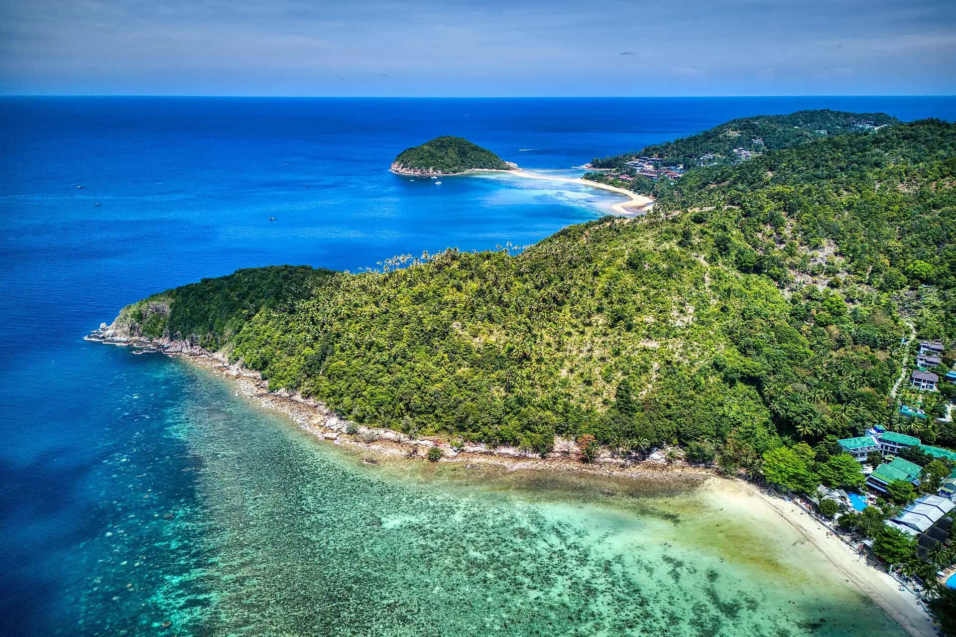 Aerial view of the reef and forested headland near Mae Haad, with Koh Ma joined by a sandbar